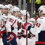 
              Washington Capitals center Evgeny Kuznetsov (92) is congratulated by right wing Tom Wilson (43) and the bench after scoring a goal against the Minnesota Wild during the second period of an NHL hockey game Saturday, Jan. 8, 2022, in St, Paul, Minn. (AP Photo/Andy Clayton-King)
            