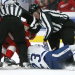 
              NHL referees try to separate Detroit Red Wings center Vladislav Namestnikov and Toronto Maple Leafs defenseman Travis Dermott (23) at the end of the second period of an NHL hockey game Saturday, Jan. 29, 2022, in Detroit. (AP Photo/Duane Burleson)
            