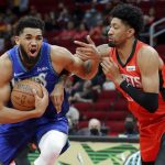 
              Minnesota Timberwolves center Karl-Anthony Towns, left, drives around Houston Rockets center Christian Wood, right, during the first half of an NBA basketball game Sunday, Jan. 9, 2022, in Houston. (AP Photo/Michael Wyke)
            