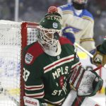 
              Minnesota Wild goaltender Cam Talbot is hit by the puck during the first period of the team's NHL Winter Classic hockey game against the St. Louis Blues on Saturday, Jan. 1, 2022, in Minneapolis. (AP Photo/Andy Clayton-King)
            