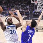 
              Minnesota Timberwolves forward Josh Okogie, left, shoots as Los Angeles Clippers guard Amir Coffey defends during the second half of an NBA basketball game Monday, Jan. 3, 2022, in Los Angeles. (AP Photo/Mark J. Terrill)
            