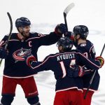 
              Columbus Blue Jackets forward Boone Jenner, left, celebrates with forward Gustav Nyquist, center, and forward Sean Kuraly after Kuraly's goal against the New York Rangers during the third period of an NHL hockey game in Columbus, Ohio, Thursday, Jan. 27, 2022. The Blue Jackets won 5-3. (AP Photo/Paul Vernon)
            