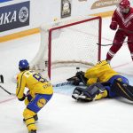 
              Russia's Vyacheslav Voynov, 2nd left, scores his side's opening goal past Sweden's goalie Magnus Hellberg goal during the Channel One Cup ice hockey match between Sweden and Russia in Moscow, Russia, Thursday, Dec. 16, 2021. (AP Photo/Pavel Golovkin)
            