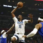 
              Minnesota Timberwolves center Naz Reid, center, shoots as Los Angeles Clippers guard Reggie Jackson, left, and forward Marcus Morris Sr. defend during the first half of an NBA basketball game Monday, Jan. 3, 2022, in Los Angeles. (AP Photo/Mark J. Terrill)
            
