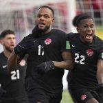
              Canada's Cyle Larin (17) celebrates his goal against the United States with teammate Richie Laryea (22) during the first half of a World Cup soccer qualifier in Hamilton, Ontario, Sunday, Jan. 30, 2022. (Nathan Denette/The Canadian Press via AP)
            