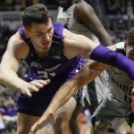 
              Northwestern forward Robbie Beran (31) reaches for a loose ball with Purdue forward Mason Gillis (0) in the first half of an NCAA college basketball game in West Lafayette, Ind., Sunday, Jan. 23, 2022. (AP Photo/AJ Mast)
            