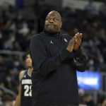 
              Georgetown head coach Patrick Ewing applauds while watching a replay on the videoboard during the first half of an NCAA college basketball game against Providence, Thursday, Jan. 20, 2022, in Providence, R.I. (AP Photo/Stew Milne)
            