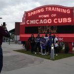 
              FILE - Fans take a photo in front of the Chicago Cubs Spring Training sign before a spring training baseball game against the Los Angeles Dodgers Thursday, March 25, 2021, in Mesa, Ariz. Spring training games might not count in the official standings, but they certainly count for the pocketbooks of business owners in Arizona and Florida. They're also a much-anticipated destination for fans who come for the warm sunshine and the laid-back atmosphere. (AP Photo/Ashley Landis, File)
            