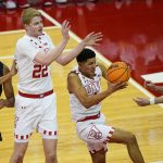 
              Wisconsin's Johnny Davis, second from right, grabs a defensive rebound against Iowa's Kris Murray (24) and Patrick McCaffery, right, during the first half of an NCAA college basketball game Thursday, Jan. 6, 2022, in Madison, Wis. (AP Photo/Andy Manis)
            