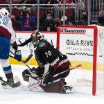 
              Colorado Avalanche's Nathan MacKinnon (29) scores against the Arizona Coyotes' goalkeeper Karel Vehmelka (70) during the first period of an NHL hockey game Saturday, Jan. 15, 2022, in Glendale, Ariz. (AP Photo/Darryl Webb)
            