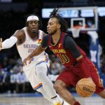 
              Cleveland Cavaliers guard Darius Garland (10) drives against Oklahoma City Thunder guard Luguentz Dort in the first half of an NBA basketball game Saturday, Jan. 15, 2022, in Oklahoma City. (AP Photo/Nate Billings)
            