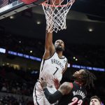
              Brooklyn Nets forward Kevin Durant, left, dunks over Portland Trail Blazers guard Ben McLemore during the second half of an NBA basketball game in Portland, Ore., Monday, Jan. 10, 2022. (AP Photo/Craig Mitchelldyer)
            