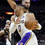 
              Los Angeles Lakers guard Russell Westbrook (0) drives to the basket as Miami Heat guard Max Strus defends during the first half of an NBA basketball game, Sunday, Jan. 23, 2022, in Miami. (AP Photo/Lynne Sladky)
            