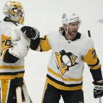 
              Pittsburgh Penguins goaltender Louis Domingue, left, celebrates with center Jeff Carter (77) after the Penguins defeated the San Jose Sharks in an NHL hockey game in San Jose, Calif., Saturday, Jan. 15, 2022. The Penguins won, 2-1, in overtime. (AP Photo/Jeff Chiu)
            
