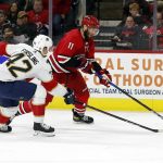 
              Carolina Hurricanes' Jordan Staal (11) moves the puck up the ice past Florida Panthers' Gustav Forsling (42) during the second period of an NHL hockey game in Raleigh, N.C., Saturday, Jan. 8, 2022. (AP Photo/Karl B DeBlaker)
            