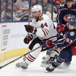 
              Chicago Blackhawks' Calvin de Haan, left, and Columbus Blue Jackets' Jakub Voracek chase a loose puck during the second period of an NHL hockey game Tuesday, Jan. 11, 2022, in Columbus, Ohio. (AP Photo/Jay LaPrete)
            