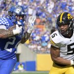 
              Kentucky running back Chris Rodriguez Jr. (24) rushes for yardage in front of Iowa linebacker Jestin Jacobs (5) during the first half of the Citrus Bowl NCAA college football game, Saturday, Jan. 1, 2022, in Orlando, Fla. (AP Photo/Phelan M. Ebenhack)
            