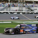 
              Austin MCClusker, (7) drives down pit road as he heads back on the track during the Rolex 24 hour auto race at Daytona International Speedway, Saturday, Jan. 29, 2022, in Daytona Beach, Fla. (AP Photo/John Raoux)
            