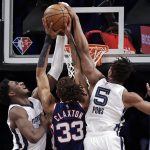 
              Brooklyn Nets forward Nic Claxton (33) is fouled by Memphis Grizzlies guard Yves Pons (5) during the first half of an NBA basketball game Monday, Jan. 3, 2022, in New York. (AP Photo/Adam Hunger)
            