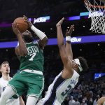 
              Boston Celtics guard Jaylen Brown (7) drives the basket against Orlando Magic center Wendell Carter Jr. (34) during the second half of an NBA basketball game, Sunday, Jan. 2, 2022, in Boston. (AP Photo/Mary Schwalm)
            