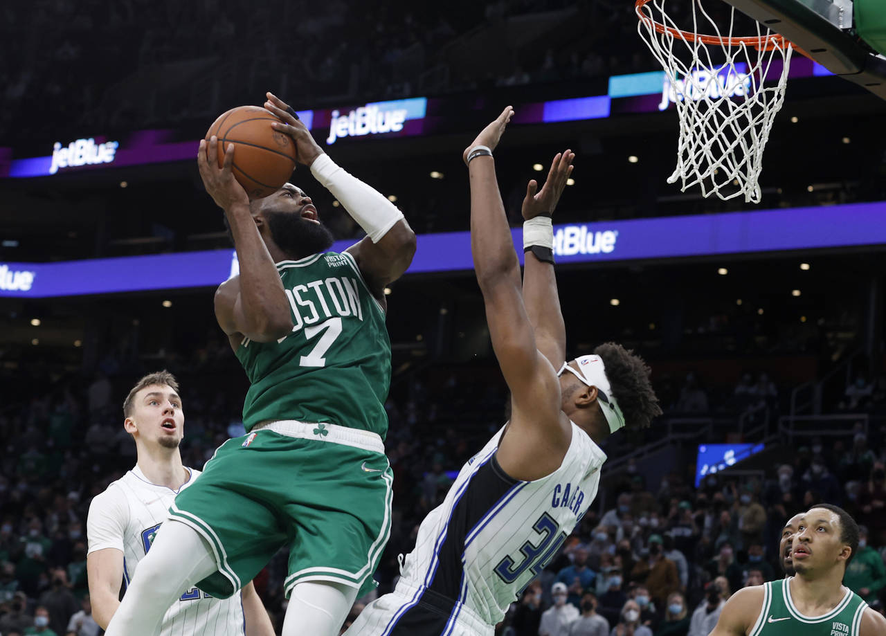 Boston Celtics guard Jaylen Brown (7) drives the basket against Orlando Magic center Wendell Carter...