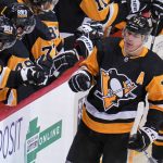 
              Pittsburgh Penguins' Evgeni Malkin (71) celebrates as he returns to the bench after scoring during the first period of the team's NHL hockey game against the Ottawa Senators in Pittsburgh, Thursday, Jan. 20, 2022. (AP Photo/Gene J. Puskar)
            
