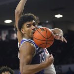 
              Kansas State guard Mark Smith (13) reaches for a rebound in front of Jalen Hill, rear, in the second half of an NCAA college basketball game Saturday, Jan. 1, 2022, in Norman, Okla. (AP Photo/Sue Ogrocki)
            