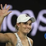 
              Ash Barty of Australia waves as she is interviewed after defeating Camila Giorgi of Italy in their third round match at the Australian Open tennis championships in Melbourne, Australia, Friday, Jan. 21, 2022. (AP Photo/Andy Brownbill)
            