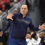
              Notre Dame head coach Mike Brey sends instructions to his team during the second half of an NCAA college basketball game against Louisville in Louisville, Ky., Saturday, Jan. 22, 2022. Notre Dame won 82-70. (AP Photo/Timothy D. Easley)
            