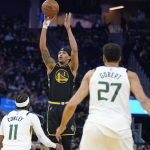
              Golden State Warriors guard Damion Lee (1) shoots a 3-point basket over Utah Jazz guard Mike Conley (11) and center Rudy Gobert (27) during the first half of an NBA basketball game in San Francisco, Sunday, Jan. 23, 2022. (AP Photo/Jeff Chiu)
            