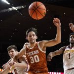
              Texas forward Brock Cunningham (30) fights for a loose ball with Iowa State guard Caleb Grill, left, and guard Izaiah Brockington (1) during the second half of an NCAA college basketball game, Saturday, Jan. 15, 2022, in Ames, Iowa. (AP Photo/Charlie Neibergall)
            