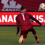 
              United States' Matt Turner (1) watches the ball fly past to score for Canada's Samuel Adekugbe during the second half of a World Cup soccer qualifier in Hamilton, Ontario, Sunday, Jan. 30, 2022. (Frank Gunn/The Canadian Press via AP)
            