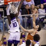 
              Texas forward Timmy Allen, right, drives to the basket against TCU guard Damion Baugh (10) in the first half of an NCAA college basketball game in Fort Worth, Texas, Tuesday, Jan. 25, 2022. (AP Photo/Gareth Patterson)
            