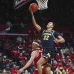 
              Michigan forward Caleb Houstan (22) is fouled by Rutgers guard Paul Mulcahy (4) during the first half of an NCAA college basketball game Tuesday, Jan. 4, 2022, in Piscataway, N.J. (Andrew Mills/NJ Advance Media via AP)
            