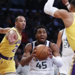 
              Utah Jazz guard Donovan Mitchell (45) drives between Los Angeles Lakers guards Russell Westbrook (0) and Avery Bradley (20) during the first half of an NBA basketball game in Los Angeles, Monday, Jan. 17, 2022. (AP Photo/Ringo H.W. Chiu)
            