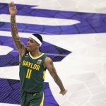 
              Baylor guard James Akinjo (11) gestures after making a three-point basket in the first half of an NCAA college basketball game against TCU in Fort Worth, Texas, Saturday, Jan. 8, 2022. (AP Photo/Emil Lippe)
            
