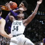 
              Northwestern's Julian Roper II, rear, pulls down a rebound over Michigan State's Julius Marble (34) during the closing seconds of the second half of an NCAA college basketball game, Saturday, Jan. 15, 2022, in East Lansing, Mich. Northwestern won 64-62. (AP Photo/Al Goldis)
            