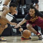 
              Brooklyn Nets' Cam Thomas, left, grabs the ball ahead of Cleveland Cavaliers' Darius Garland in the second half of an NBA basketball game, Monday, Jan. 17, 2022, in Cleveland. (AP Photo/Tony Dejak)
            