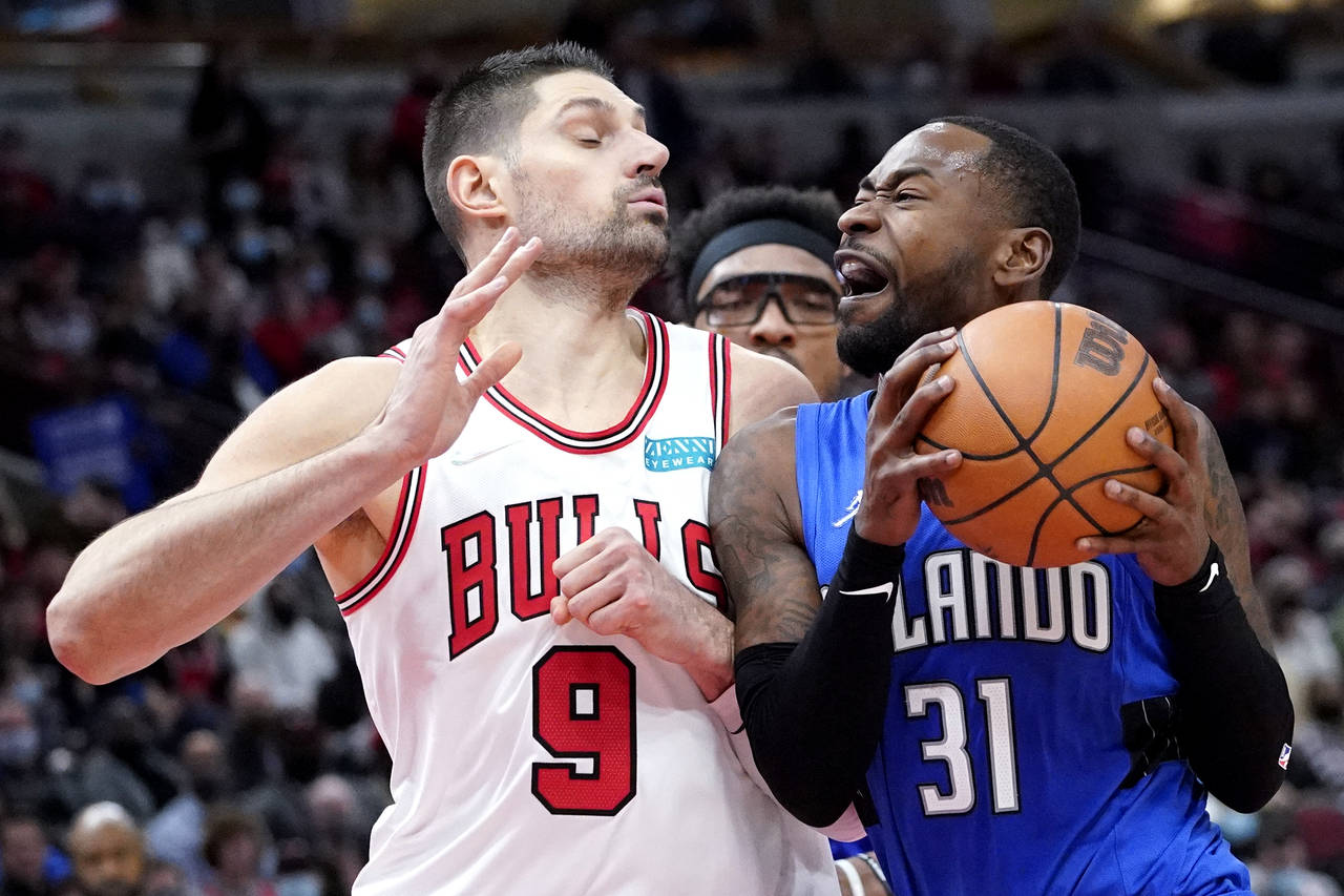 Orlando Magic guard Terrence Ross, right, drives against Chicago Bulls center Nikola Vucevic during...