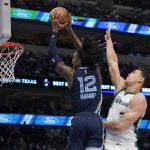 
              Memphis Grizzlies guard Ja Morant (12) goes up for a dunk after getting past Dallas Mavericks center Dwight Powell (7) in the first half of an NBA basketball game in Dallas, Sunday, Jan. 23, 2022. (AP Photo/Tony Gutierrez)
            