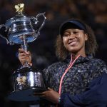 
              FILE - Japan's Naomi Osaka holds the Daphne Akhurst Memorial Cup aloft after defeating United States Jennifer Brady in the women's singles final at the Australian Open tennis championship in Melbourne, Australia, Saturday, Feb. 20, 2021. Naomi Osaka returns to the Australian Open as its defending champion and with what she says is a fresh outlook after last year’s roller-coaster. (AP Photo/Andy Brownbill, File)
            