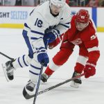 
              Detroit Red Wings defenseman Gustav Lindstrom (28) tries to steal the puck from Toronto Maple Leafs right wing Mitchell Marner (16) during the second period of an NHL hockey game Saturday, Jan. 29, 2022, in Detroit. (AP Photo/Duane Burleson)
            