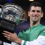 
              FILE - Serbia's Novak Djokovic holds the Norman Brookes Challenge Cup after defeating Russia's Daniil Medvedev in the men's singles final at the Australian Open tennis championship in Melbourne, Australia, Sunday, Feb. 21, 2021. Djokovic has had his visa canceled and been denied entry to Australia, Thursday, Jan. 6, 2022 and is set to be removed from the country after spending the night at the Melbourne airport as officials refused to let him enter the country for the Australian Open after an apparent visa mix-up.(AP Photo/Andy Brownbill, File)
            