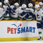
              Vancouver Canucks center Elias Pettersson (40) is congratulated after scoring a goal against the Nashville Predators during the second period of an NHL hockey game Tuesday, Jan. 18, 2022, in Nashville, Tenn. (AP Photo/Mark Zaleski)
            
