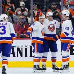 
              New York Islanders' Josh Bailey (12) celebrates with Brock Nelson (29), Anthony Beauvillier (18) and Adam Pelech (3) after scoring a goal during the second period of an NHL hockey game against the Philadelphia Flyers, Tuesday, Jan. 18, 2022, in Philadelphia. (AP Photo/Matt Slocum)
            