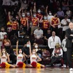 
              Fans are seen in the stand with their chests with the words "Go Zey" for Southern California forward Isaiah Mobley as California head coach Mark Fox, right, stands on the floor during the second half of an NCAA college basketball game Saturday, Jan. 29, 2022, in Los Angeles. (AP Photo/Mark J. Terrill)
            