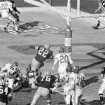 
              FILE - Green Bay Packers' Elijah Pitts (22) charges into the end zone, eluding Kansas City Chiefs' Bobby Hunt (20), during the first Super Bowl in Los Angeles, Jan. 16, 1967. (AP Photo, File)
            
