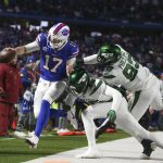 
              New York Jets defenders push Buffalo Bills quarterback Josh Allen, left, out of bounds during the second half of an NFL football game, Sunday, Jan. 9, 2022, in Orchard Park, N.Y. (AP Photo/Joshua Bessex)
            