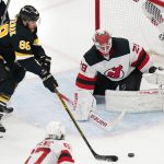 
              Boston Bruins right wing David Pastrnak (88) tracks the puck while lining up a shot against New Jersey Devils goaltender Mackenzie Blackwood (29), on which he scored, during the third period of an NHL hockey game Tuesday, Jan. 4, 2022, in Boston. The Bruins won 5-3. (AP Photo/Charles Krupa)
            