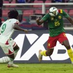 
              Cameroon's Nouhou Tolo, right, attacks as Burkina Faso's Issoufou Dayo defends during the African Cup of Nations 2022 group A soccer match between Cameroon and Burkina Faso at the Olembe stadium in Yaounde, Cameroon, Sunday, Jan. 9, 2022. (AP Photo/Themba Hadebe)
            